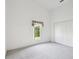 Cozy bedroom with a window and spacious closet, creating a comfortable living space at 4320 Northampton Dr, New Port Richey, FL 34653