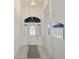 Bright foyer with tile flooring, decorative front door and transom window at 4320 Northampton Dr, New Port Richey, FL 34653
