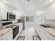 Bright kitchen with stainless steel appliances, white cabinetry, and marble countertops at 4320 Northampton Dr, New Port Richey, FL 34653