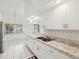 Bright eat-in kitchen with white cabinets and marble countertops at 4320 Northampton Dr, New Port Richey, FL 34653