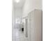 Well-lit laundry room with tile floors, washer, dryer, sink, and ample white cabinet space at 4320 Northampton Dr, New Port Richey, FL 34653