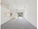 Spacious, carpeted living room with sliding glass doors to the outdoor area at 4320 Northampton Dr, New Port Richey, FL 34653