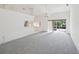Large, bright living area with plush carpeting and an open layout at 4320 Northampton Dr, New Port Richey, FL 34653