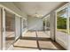 Relaxing screened porch with tile flooring, ceiling fan, and views of the outdoors at 4320 Northampton Dr, New Port Richey, FL 34653