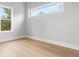 Bedroom featuring hardwood floors and ample natural light from two large windows at 224 N Hesperides St, Tampa, FL 33609