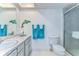 Bright bathroom featuring a marble countertop, a dolphin decoration, and a glass enclosed shower at 5220 Brittany S Dr # 807, St Petersburg, FL 33715