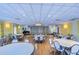 Large event space with tables, chairs, a chandelier, and a stage with a piano at 5220 Brittany S Dr # 807, St Petersburg, FL 33715