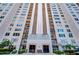 High-rise building featuring residential units and balconies and well-maintained landscaping at 5220 Brittany S Dr # 807, St Petersburg, FL 33715