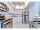 Bright, all-white kitchen with stainless steel appliances; featuring a modern design and ample counter space at 5220 Brittany S Dr # 807, St Petersburg, FL 33715