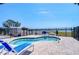 Kidney-shaped pool surrounded by brick pavers, chaise lounges, and black fence at 5220 Brittany S Dr # 807, St Petersburg, FL 33715