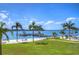 Beautiful waterfront with palm trees, beach, boat dock, and blue sky at 5220 Brittany S Dr # 807, St Petersburg, FL 33715