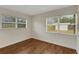 Bedroom with wood floors and two bright windows at 5813 18Th S Ave, Gulfport, FL 33707