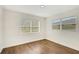 Bedroom with laminate flooring and two windows at 5813 18Th S Ave, Gulfport, FL 33707