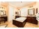 Lavish bathroom featuring granite countertops, double vanities, and a large bathtub at 6021 Flatwoods Manor Cir, Lithia, FL 33547