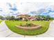 Attractive home with a terracotta roof, a well-manicured lawn, and a decorative flower bed at 6021 Flatwoods Manor Cir, Lithia, FL 33547