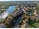 An aerial view shows this community's pool, mature landscaping, and buildings near a winding river at 6330 Newtown Cir # 30B4, Tampa, FL 33615
