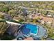 Aerial view of a sparkling community pool surrounded by lush landscaping and apartment buildings at 6330 Newtown Cir # 30B4, Tampa, FL 33615