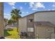 View of the building exterior with pool and palm trees; perfect for outdoor enjoyment at 6330 Newtown Cir # 30B4, Tampa, FL 33615