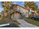 Exterior view of a two-story condo building with private balconies surrounded by palm trees and lush landscaping at 6330 Newtown Cir # 30B4, Tampa, FL 33615