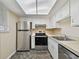 Well-lit kitchen with stainless steel appliances and ample counter space at 6330 Newtown Cir # 30B4, Tampa, FL 33615
