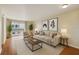 Staged living room with a couch, coffee table, and large windows at 6330 Newtown Cir # 30B4, Tampa, FL 33615