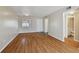 Bright living room with wood floors and a view into the bathroom at 6330 Newtown Cir # 30B4, Tampa, FL 33615