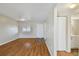 Cozy living room featuring wood floors, neutral walls, and view into the bathroom at 6330 Newtown Cir # 30B4, Tampa, FL 33615