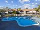 Community pool with nearby seating and well-maintained grounds, perfect for relaxation at 6330 Newtown Cir # 30B4, Tampa, FL 33615