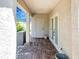 Covered back porch with brick flooring, storage container, and convenient access to exterior doors at 7101 8Th N Ave, St Petersburg, FL 33710
