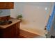 Bathroom features wooden vanity, tiled walls, and white bathtub at 7101 8Th N Ave, St Petersburg, FL 33710