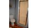 Bathroom with wood floors, gray walls, and enclosed shower with metal trim at 7101 8Th N Ave, St Petersburg, FL 33710