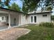 Rear exterior view of home featuring French doors, EV charger, and brick-paved drive at 7101 8Th N Ave, St Petersburg, FL 33710