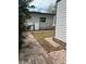 Back exterior of the home featuring Tesla power storage units and a brick paver walkway at 7101 8Th N Ave, St Petersburg, FL 33710