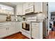 Well-lit kitchen with white cabinets, ample counter space, and modern appliances at 7101 8Th N Ave, St Petersburg, FL 33710