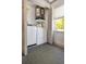Laundry room with white washer, dryer, and hot water heater at 7101 8Th N Ave, St Petersburg, FL 33710