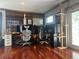 Living room with hardwood floors, desks, and cat tree at 7101 8Th N Ave, St Petersburg, FL 33710