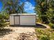 Storage shed with brick paver ground covering, trees, and grass area at 7101 8Th N Ave, St Petersburg, FL 33710