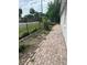 Sideyard view of brick walkway and garden area at 7101 8Th N Ave, St Petersburg, FL 33710