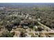 Scenic aerial perspective of homes amid lush trees, with glimpses of a lake and a tranquil community at 8539 Orbit Ave, New Port Richey, FL 34654