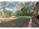 The backyard offers plenty of green space, mature trees, and storage shed at 8539 Orbit Ave, New Port Richey, FL 34654