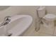 Clean bathroom featuring a white toilet, sink, and tile flooring at 10967 Carlton Fields Dr, Riverview, FL 33579