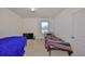 A simple bedroom with two beds and a window for natural light at 10967 Carlton Fields Dr, Riverview, FL 33579
