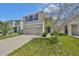 Two-story home featuring a two car garage, neutral paint, and tidy landscaping under a blue sky at 10967 Carlton Fields Dr, Riverview, FL 33579