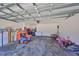 Spacious garage with concrete flooring, ample storage space, and a visible garage door mechanism at 10967 Carlton Fields Dr, Riverview, FL 33579