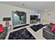 Spacious living room featuring modern decor, a large TV, and sliding glass doors at 10967 Carlton Fields Dr, Riverview, FL 33579