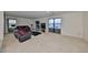 Spacious living room with modern furnishings, a large TV, and natural light from a sliding door at 10967 Carlton Fields Dr, Riverview, FL 33579