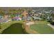 Bird's eye view of golf course community with serene pond and beautifully landscaped homes at 11013 Moshie Ln, San Antonio, FL 33576