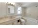 Neutral toned bathroom featuring a tub, toilet, and vanity sink with drawers at 1137 54Th S Ave, St Petersburg, FL 33705