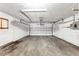 Spacious garage featuring a roll-up door, concrete floor, and electrical panel at 1137 54Th S Ave, St Petersburg, FL 33705