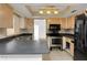 Functional kitchen with updated appliances and dark countertops at 1137 54Th S Ave, St Petersburg, FL 33705